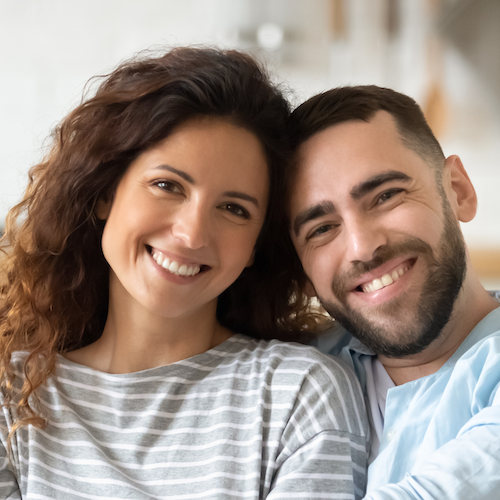 child with curly hair smiling