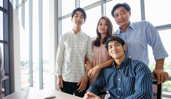 mother, father and two sons posing together